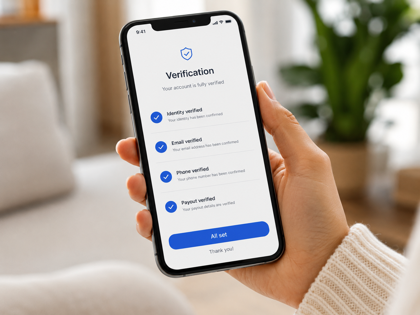 Hand holding a smartphone showing a completed verification screen.